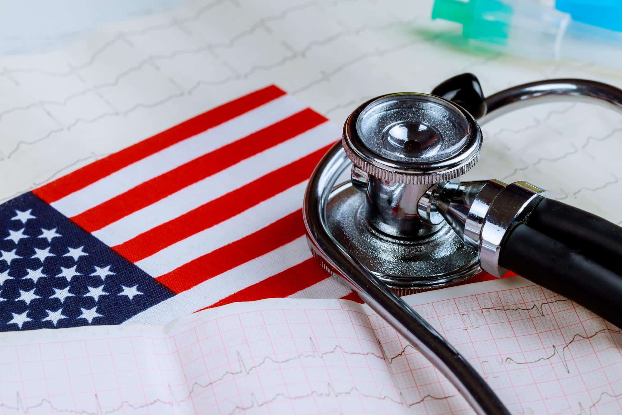 US flag, stethoscope and immigration medical exam documents on a clinic desk